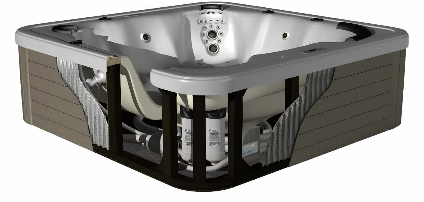 Doorsnede van een spa van Harmonic Hot Tubs: de acrylkuip, de schuimisolatie, het houten frame, het leidingwerk en de filtercartridges onder de kast zijn zichtbaar